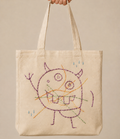 Canvas tote embroidered with a child's monster drawing